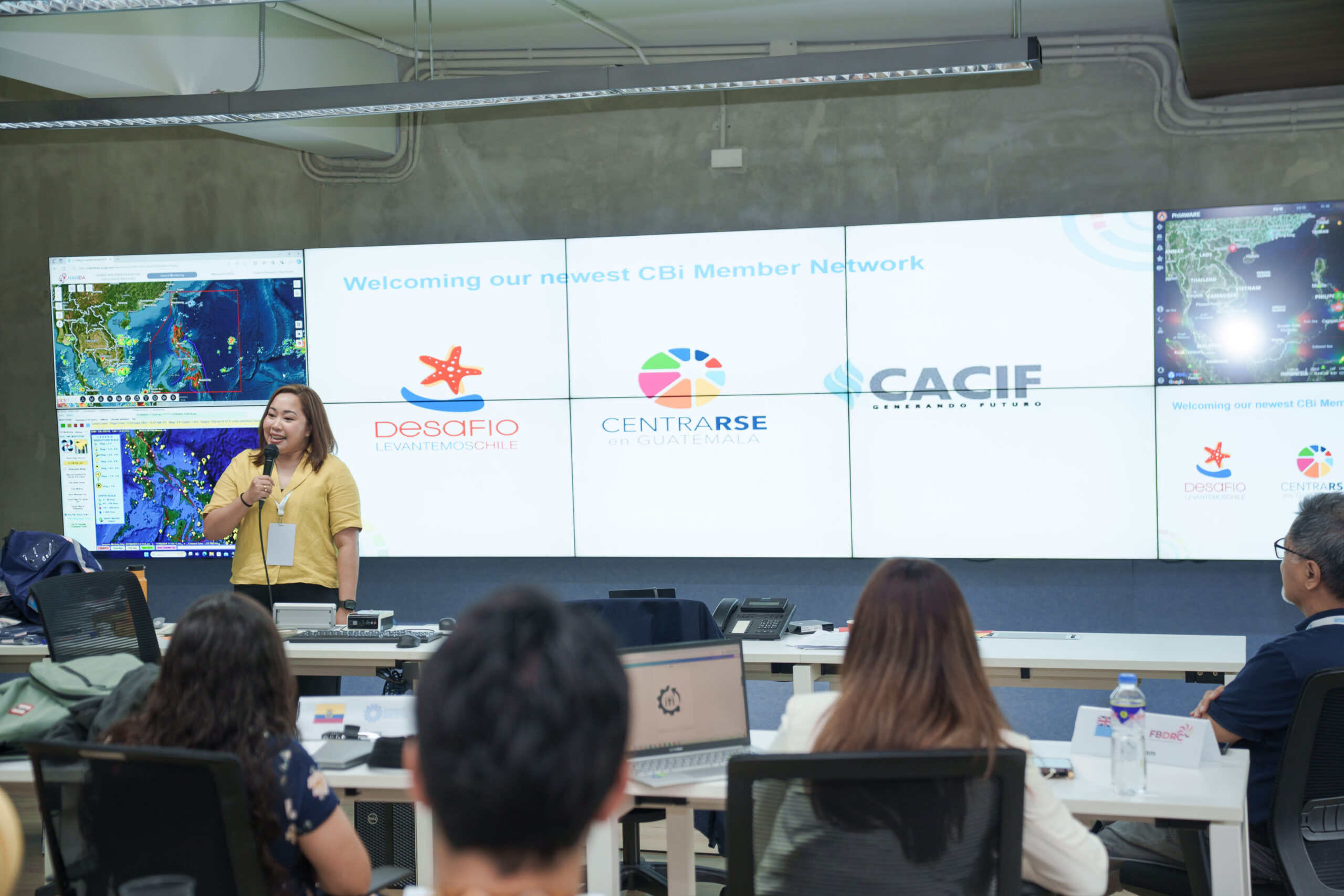 Florian Rhiza Nery, CBi's Deputy Programme Manager, welcomes three new Member Networks - represented in this visual by their logos - into the CBi community. This took place during the closing ceremony of the BEOC course hosted by CBi and the Philippine Disaster Resilience Foundation in the Philippines last week. Photo: CBi